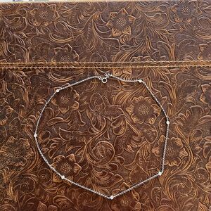 Elegant 18k white gold Necklace with 7 bezel set diamonds.